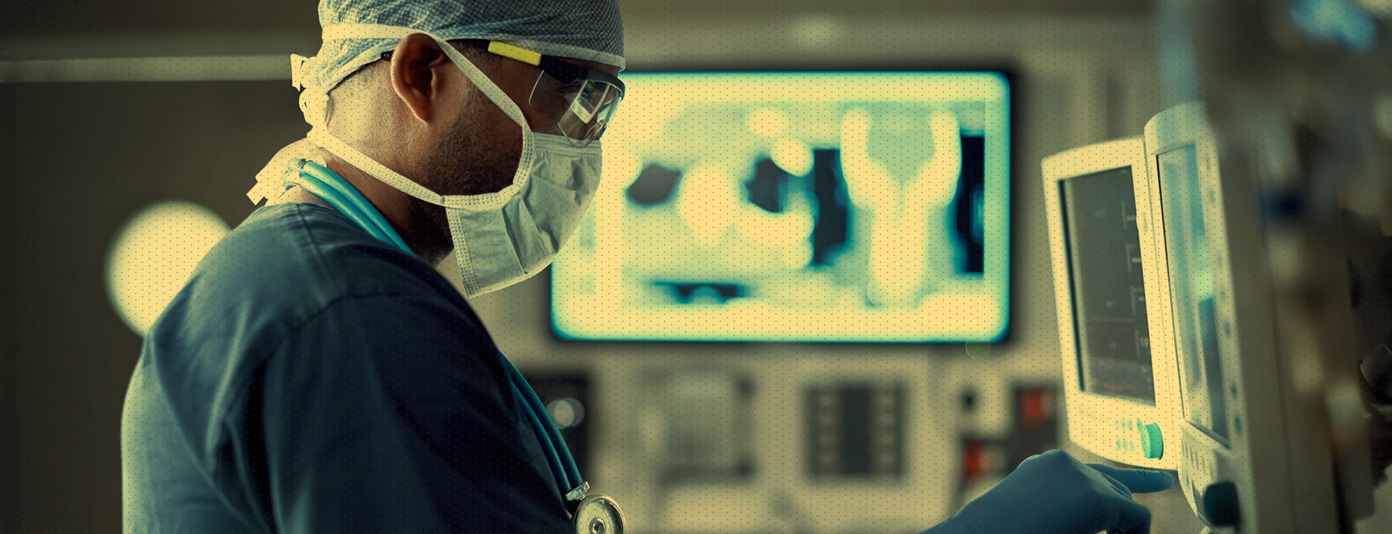 Medical doctor in operating room intently focuses on a computer screen