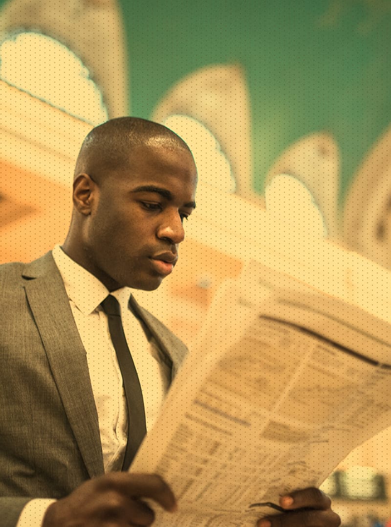 Male in suit reading a newspaper