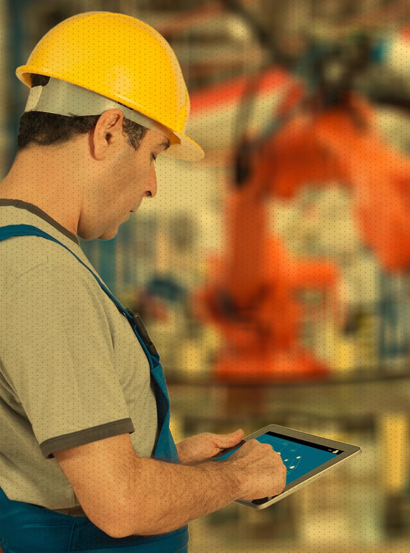 Man with yellow hard hat working in manufacturing plant