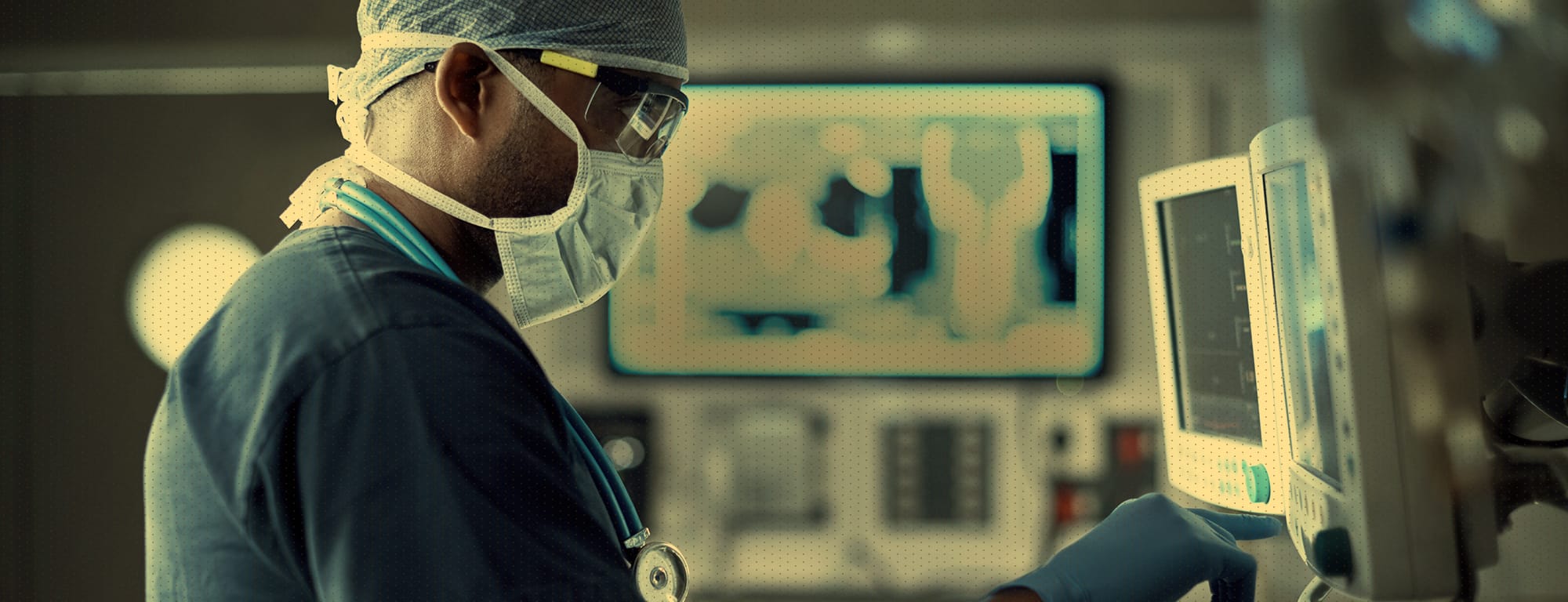 Medical doctor in operating room intently focuses on a computer screen