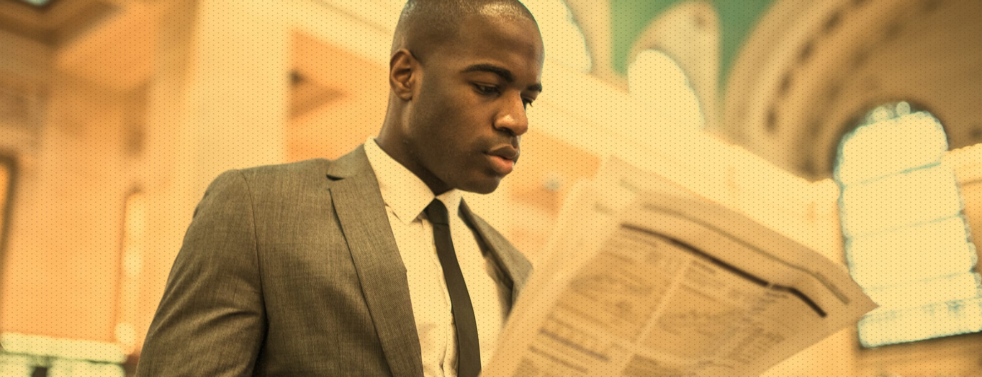 Male in suit reading a newspaper