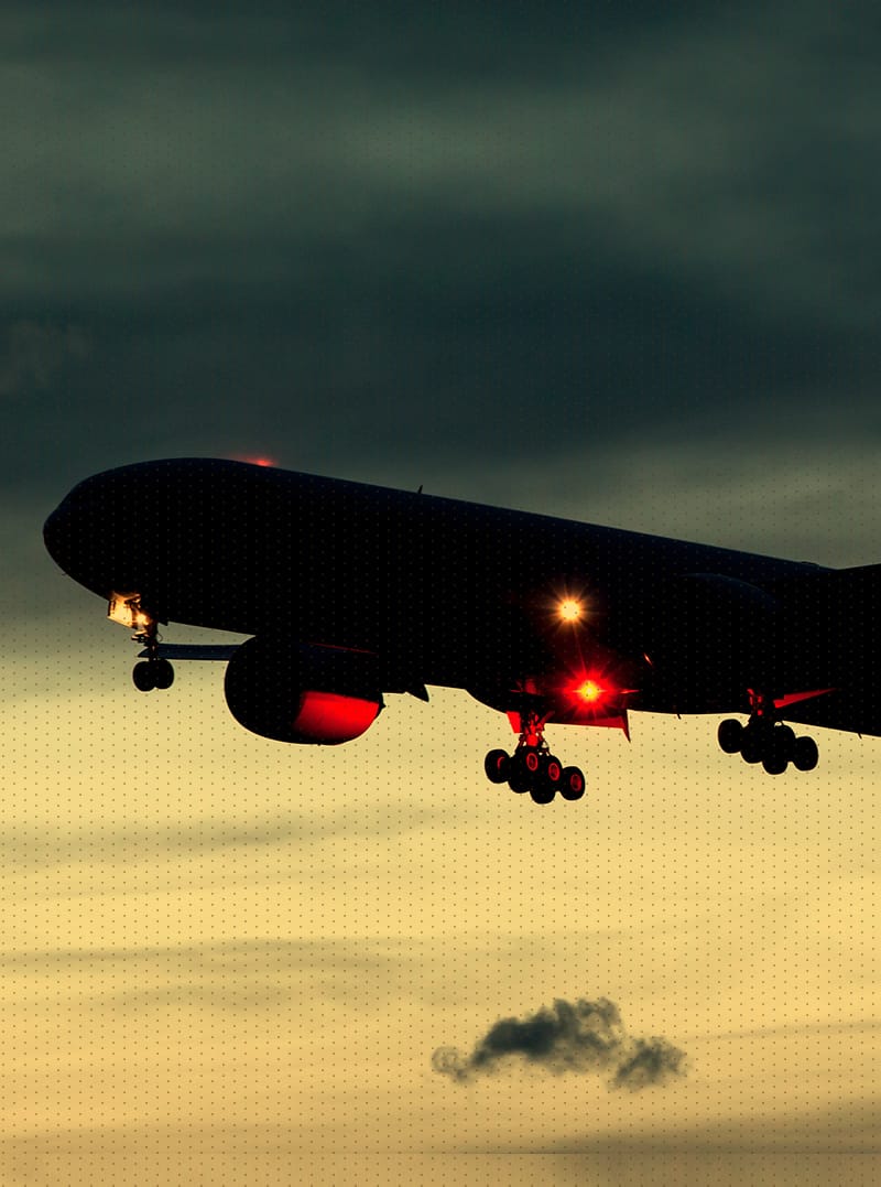 Airplane with landing gears down and lights on