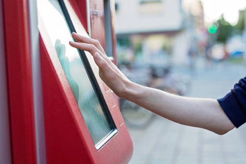 Human hand on kiosk screen