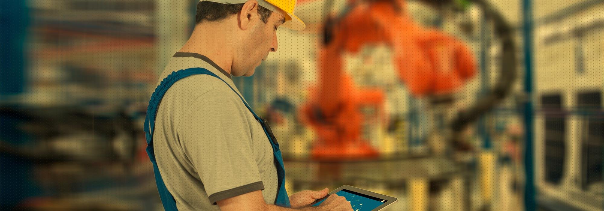 Man with yellow hard hat working in manufacturing plant