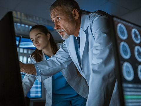 Doctors looking at medical equipment