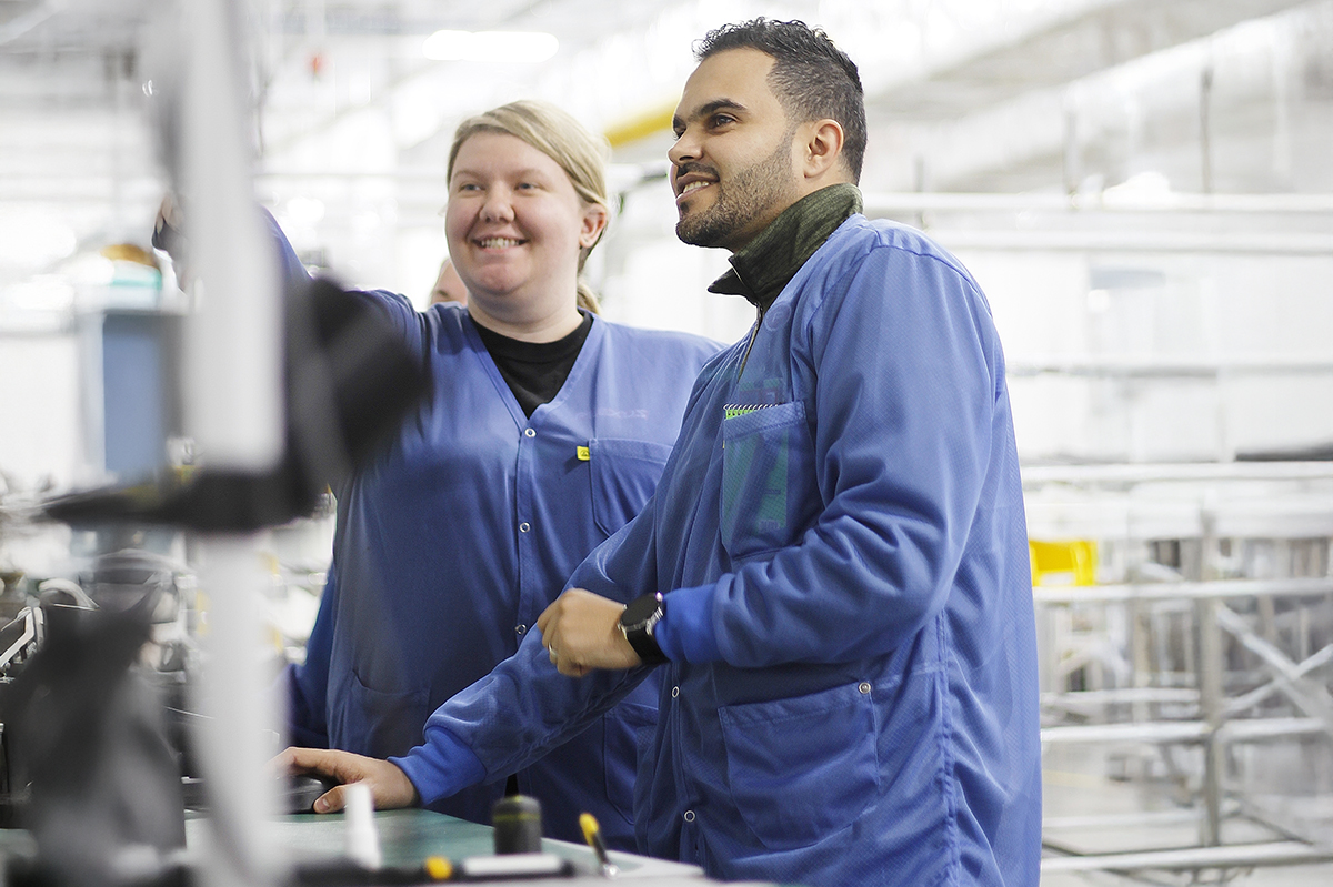 Two Plexus employees looking at a screen