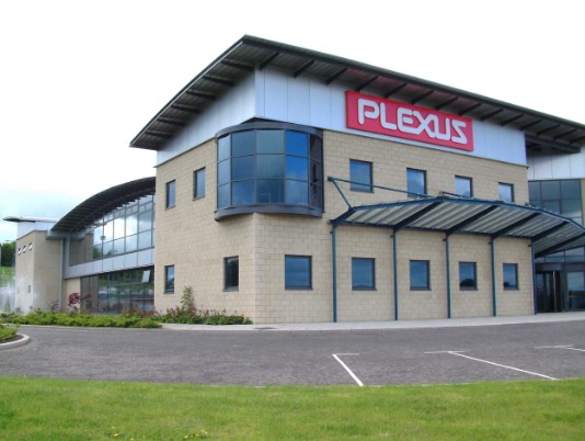 A building with a tan brick facade and a Plexus sign on the front, identified as the Plexus Kelso site in the United Kingdom.
