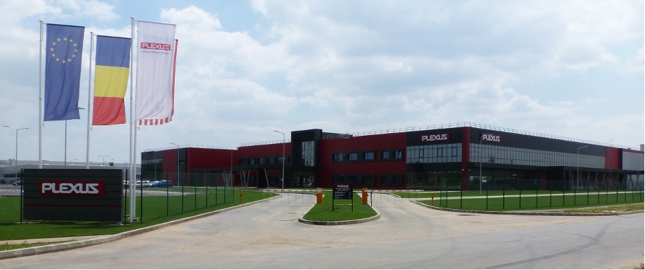 A large building with a dark red facade and a Plexus sign on the front, identified as the Plexus Oradea site in Romania.