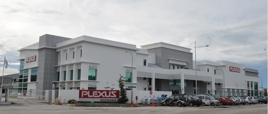 A building with a white and gray facade and a Plexus sign on the front, identified as the Plexus Penang Riverside site in Malaysia.