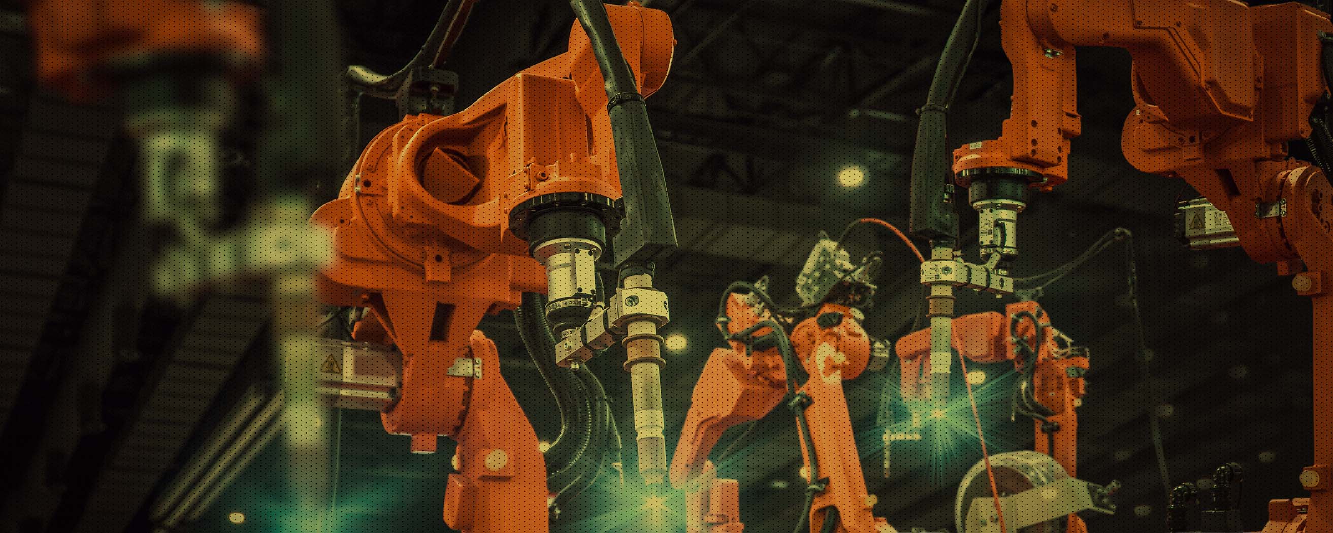 Industrial robotic arms operate in a high-tech manufacturing facility, showcasing automation and precision engineering.