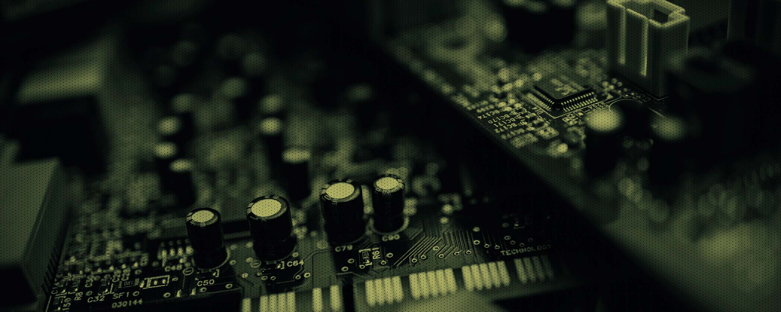 A close-up view of an electronic circuit board featuring capacitors, microchips, and intricate pathways, highlighting advanced technology and hardware design.