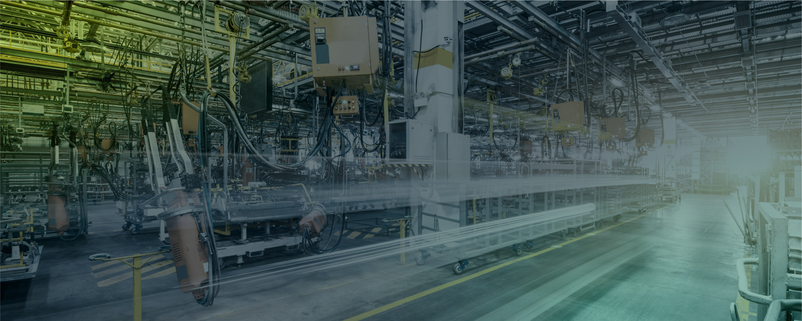 high-tech, automated factory or manufacturing facility filled with robotic arms, machinery, and overhead wiring