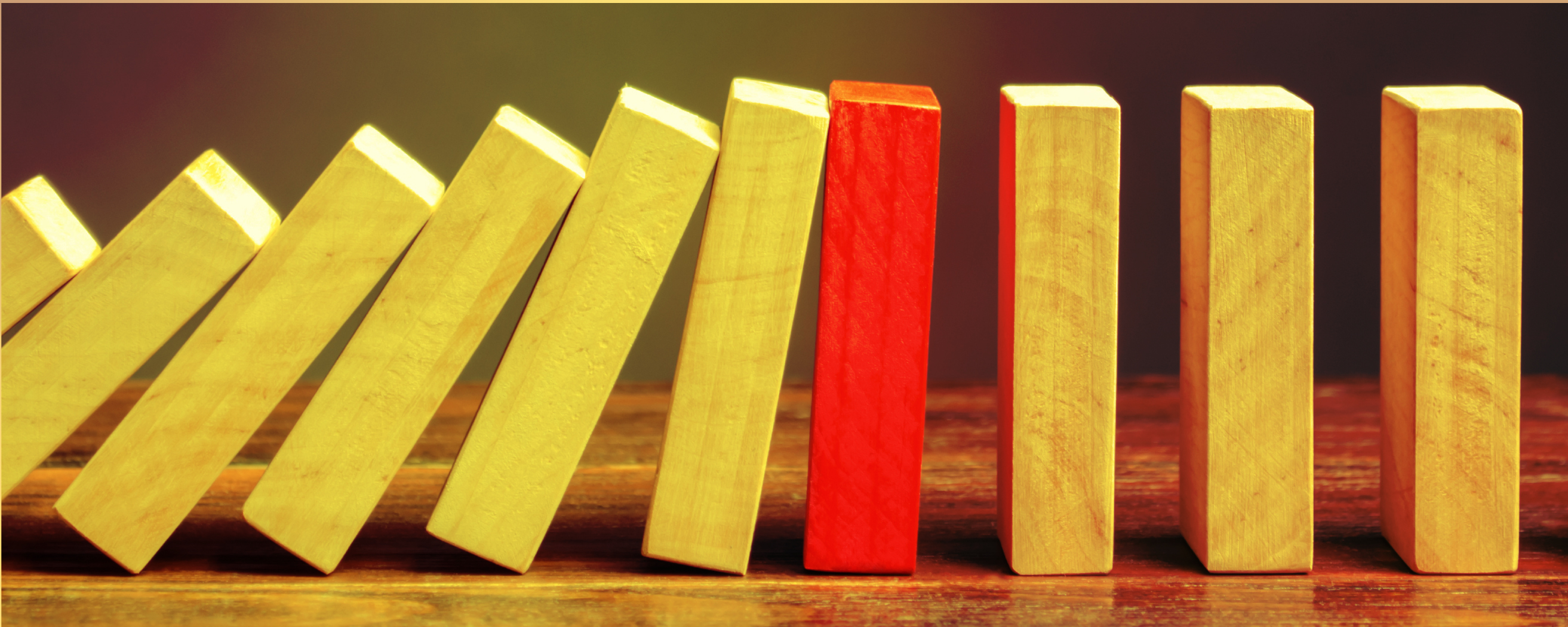 wooden blocks leaning on each other with a red box in center