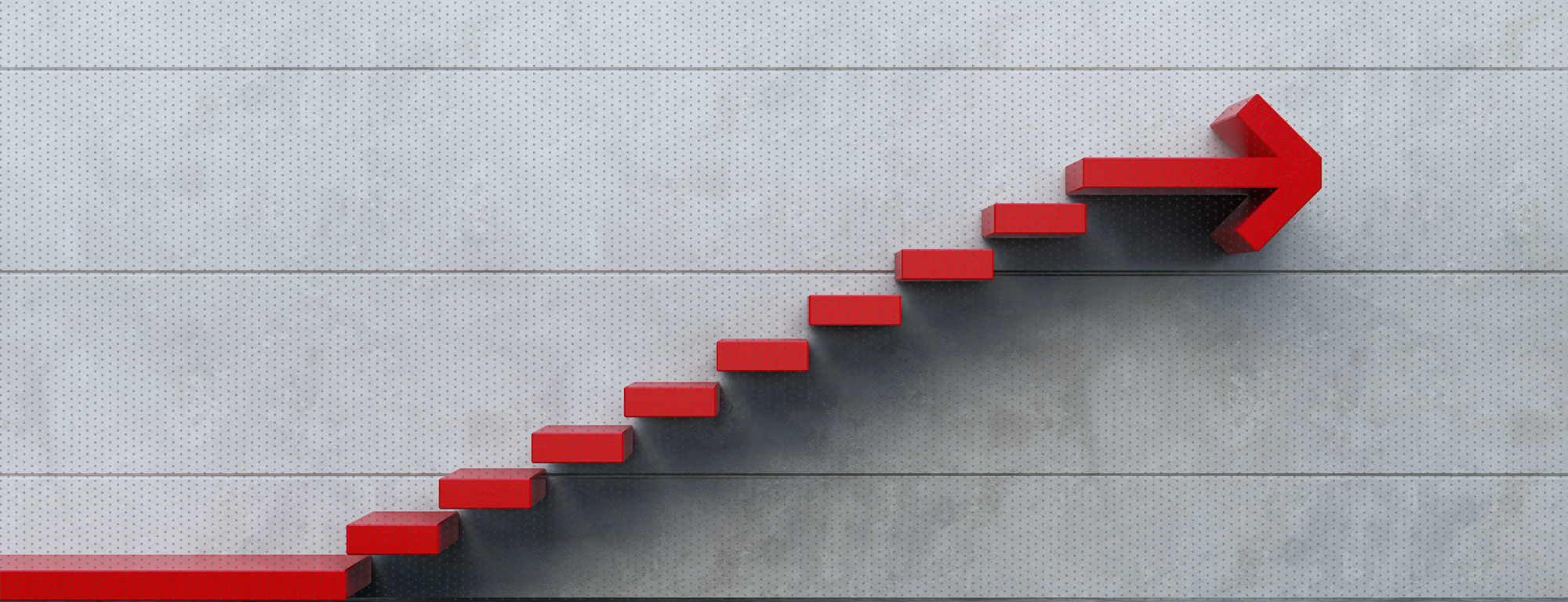 A red staircase forming an upward arrow on a concrete wall, symbolizing growth, progress, and forward momentum.