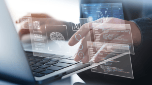A person's hands are seen typing on a laptop keyboard, overlaid with a futuristic, transparent digital interface. The interface features the letters 'AI', a graphic of a stylized human brain or neural network, and various data dashboards and progress circles.